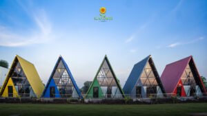 Colorful A-frame cottages under bright blue countryside skies
